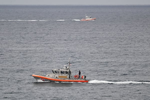 U.S Coast Guard boats look for survivors after a boat capsized in the surf Monday, May 5, 2025, at Torrey Pines State beach in San Diego, Calif. (AP Photo/Denis Poroy)