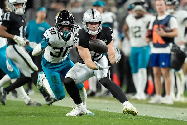 FILE - Las Vegas Raiders tight end Brock Bowers, right, makes a catch in front of Jacksonville Jaguars cornerback Montaric Brown (30) during the second half of an NFL football game Sunday, Dec. 22, 2024, in Las Vegas. The Raiders won 19-14.(AP Photo/John Locher, File)