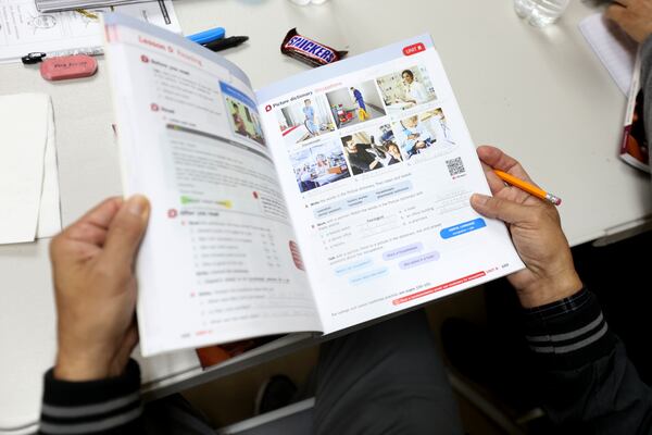 A second-level student reviews his workbook during class on Nov. 11, 2021. The mission of the Department of English Literacy at the Center for Pan Asian Community Services is to provide diverse education and learning opportunities through services, resources and collaborations with organizations. (Miguel Martinez for The Atlanta Journal-Constitution)