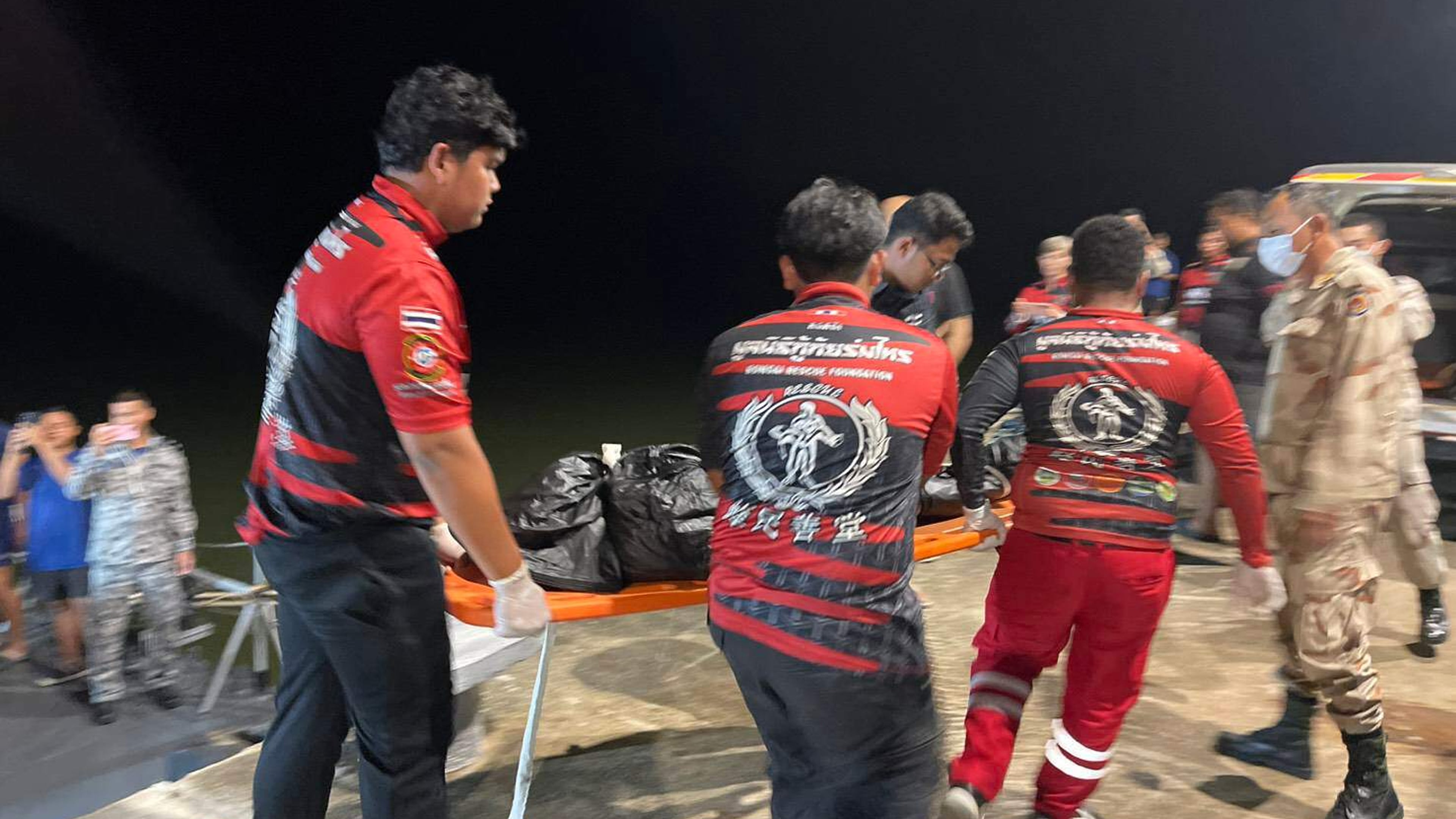 In this image released by Romsai Rescue Foundation Satun, Thai Navy carry a body which is believed to be one of passengers from a boat that believed sank near Tarutao island, Satun, southern Thailand, Sunday, Nov. 9, 2025. (Romsai Rescue Foundation Satun via AP)