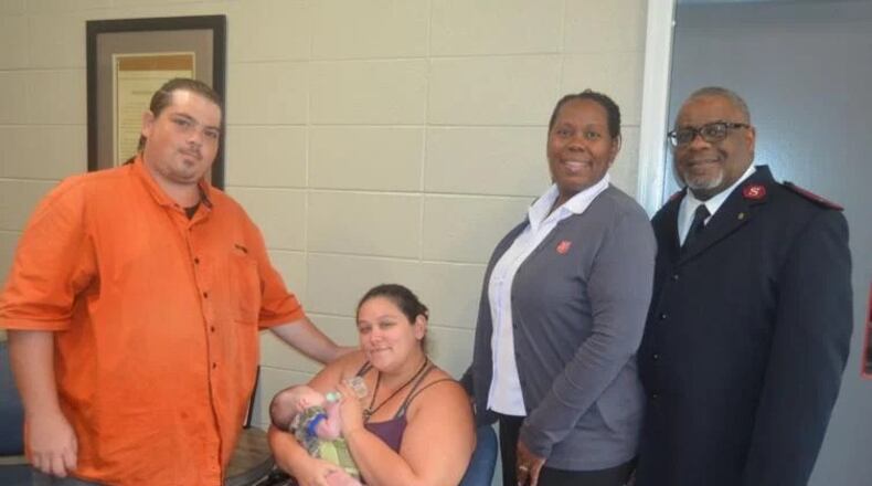 From left, Justin Miller, his wife Britney Miller, holding Baby Rwby, and Salvation Army Capts. Tasha Thomas and Chris Thomas have been caring for the infant since she was born on July 29. It is the first birth for a family staying at the facility while living in one of the recently opened family units at the shelter. (Photo Courtesy of Alan Mauldin)