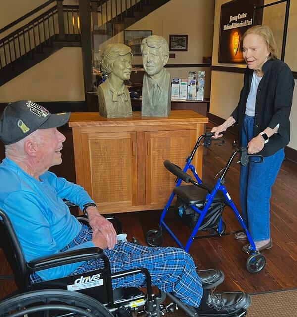 Former President Jimmy Carter and former First Lady Rosalynn Carter share big smiles in front of busts of them during a March visit to the Jimmy Carter National Historical Park in Plains. The couple celebrated their 76th wedding anniversary on July 7, 2022.