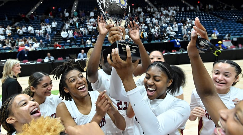 Hebron Christian players celebrate their win over Wesleyan during GHSA Basketball Class 3A Girl’s State Championship game at the Macon Centreplex, Friday, Mar. 8, 2024, in Macon. Hebron Christian won 62-60 over Wesleyan. (Hyosub Shin / Hyosub.Shin@ajc.com)