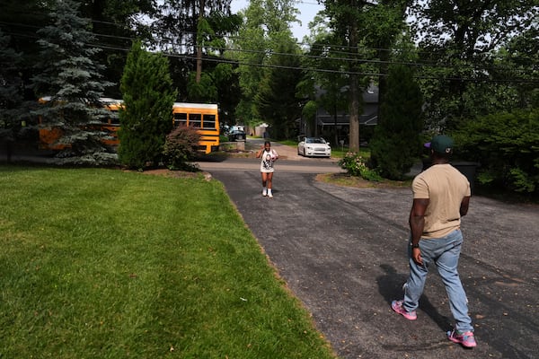 Evan Polk, right, walks to greet his daughter, Jordyn Polk, 13, from the bus after school in Secane, Pa., Thursday, June 5, 2025. (AP Photo/Matt Slocum)