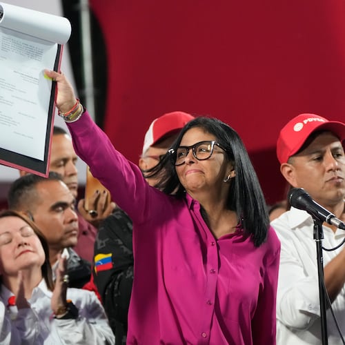 Venezuela's acting President Delcy Rodriguez takes part in a rally holding up a copy of a new law after lawmakers approved legislation opening the nation's oil sector to privatization, at the Miraflores Palace in Caracas, Venezuela, Thursday, Jan. 29, 2026. (AP Photo/Ariana Cubillos)