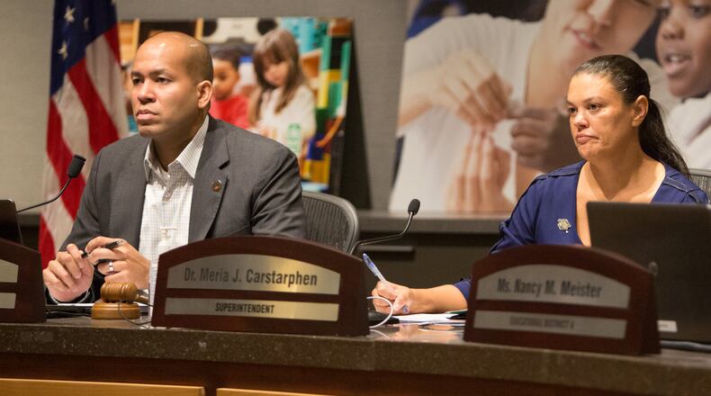 The Atlanta school board chairman Jason Esteves, left, and Superintendent Meria Carstarphen listen to public comment during a special meeting on Sept. 9, 2019, to discuss whether to extend Carstarphen’s contract. PHIL SKINNER
