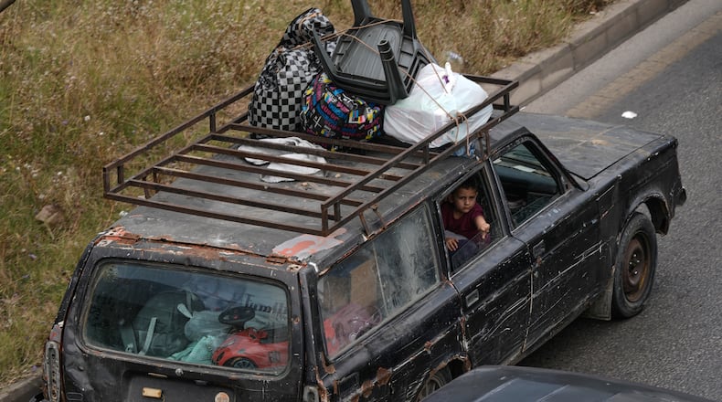 A family flees following an Israeli threat to strike Dahiyeh, Beirut's southern suburbs, Lebanon, Monday, June 1, 2026. (AP Photo/Bilal Hussein)