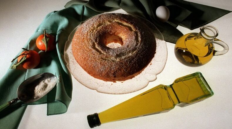 KRT FOOD STORY SLUGGED: OLIVEOIL KRT PHOTOGRAPH BY BARRY WONG/SEATTLE TIMES (KRT1-February  9)  Orange Chiffon Cake is as refreshing as it is light, even with a half cup of olive oil in the batter. Prompted by the popularity of Mediterranean cuisine, many recipes for baked goods are substituting olive oil for butter or margarine. In addition to tasting good, olive oil seems to be good for your heart, or at least better than certain other fats like butter. (SE) AP, PL (jak41556) 1998 (COLOR) NO MAGS, NO SALES