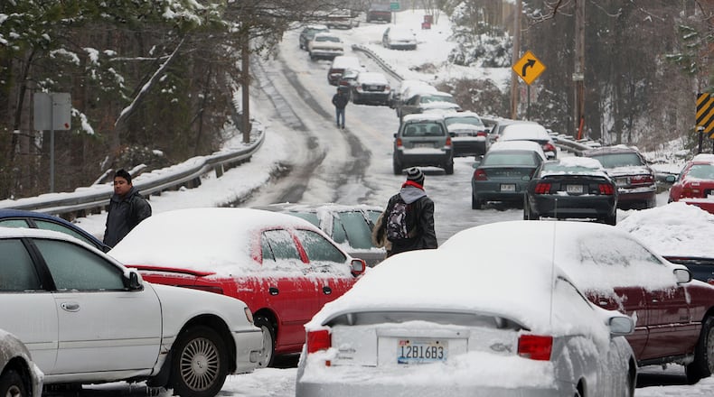 Abandoned snow and ice covered vehicles litter the 1800 block of Dawson Blvd. in Norcross in this Jan. 11, 2011 file photo.