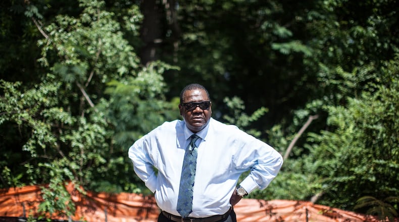 Richard Thomas stands near where members of his family are buried in Atlanta. On Sunday, June 14, 2015, Thomas stopped to visit family graves at Piney Grove Cemetery in Buckhead, only to find the old church site covered in asphalt and new condos under construction. BRANDEN CAMP/SPECIAL