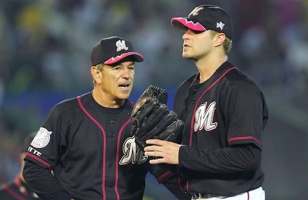 FILE - Chiba Lotte Marines manager Bobby Valentine, left, talks with his starter Dan Serafini, formerly of the Cincinnati Reds, during the fifth inning of Game Four in the Japan Series baseball game against the Hanshin Tigers at Koshien Stadium in Nishinomiya, western Japan, Wednesday, Oct. 26, 2005. (AP Photo/Shizuo Kambayashi, File)