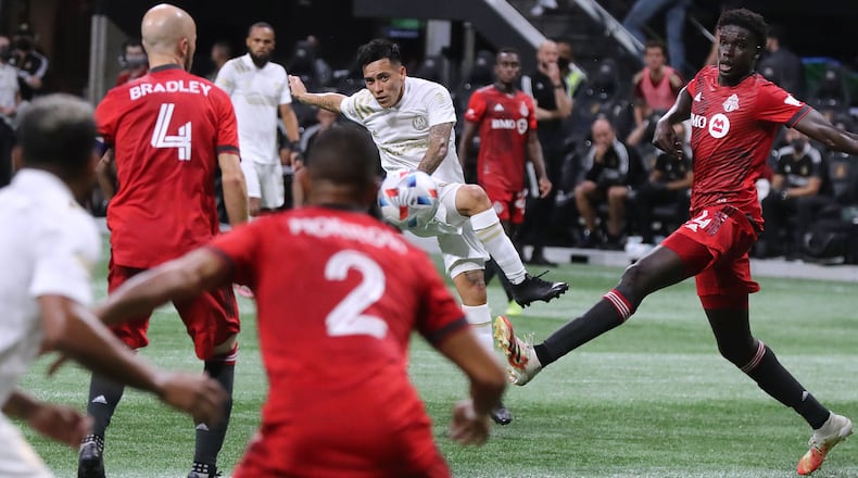 081821 Atlanta: Atlanta United midfielder Ezequiel Barco, who had the only goal of the match, takes a shot on goal through multiple Toronto FC defenders during the second half in a MLS soccer match on Wednesday, August 18, 2021, in Atlanta. ���Curtis Compton / Curtis.Compton@ajc.com���