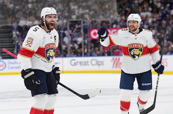 Florida Panthers' Aaron Ekblad (5) celebrates his goal against the Toronto Maple Leafs with Sam Reinhart (13) during first period NHL playoff hockey action in Toronto on Wednesday, May 14, 2025. (Nathan Denette/The Canadian Press via AP)