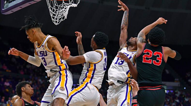 LSU forward Alex Fudge (3), guard Brandon Murray (0) and forward Tari Eason (13) and Georgia senior Braelen Bridges vie for a rebound Wednesday night in Baton Rouge, Louisiana. (Hilary Scheinuk/The Advocate via AP)