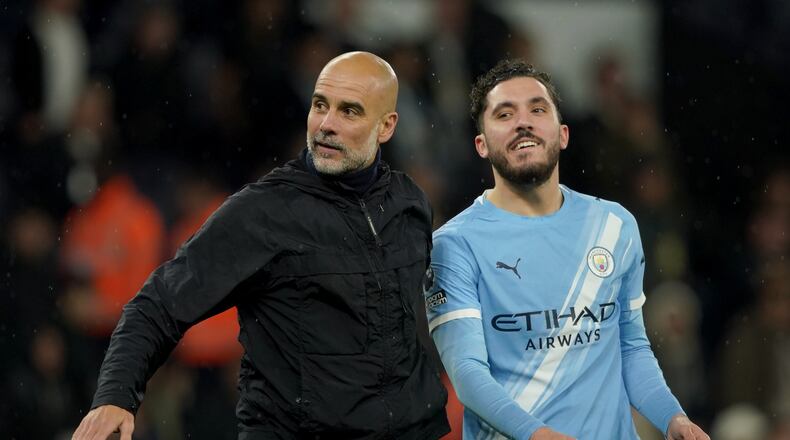 Manchester City's head coach Pep Guardiola, left, celebrates with Manchester City's Rayan Cherki at the end of the English Premier League soccer match between Manchester City and Crystal Palace in Manchester, England, Wednesday, May 13, 2026. (AP Photo/Ian Hodgson)