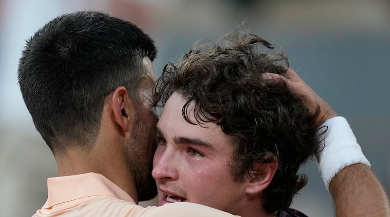 Novak Djokovic of Serbia, left, and Joao Fonseca of Brazil hug after their third round men's singles tennis match at the French Open tennis tournament in Paris, Friday, May 29, 2026. (AP Photo/Christophe Ena)