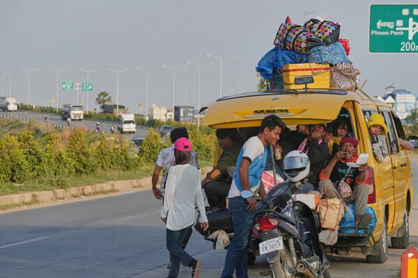 Cambodian garment workers heading to their home village to celebrate the traditional New Year holidays sit in an overcrowded van on the outskirts of Phnom Penh, Cambodia, Saturday, April 12. 2025. (AP Photo/Heng Sinith)