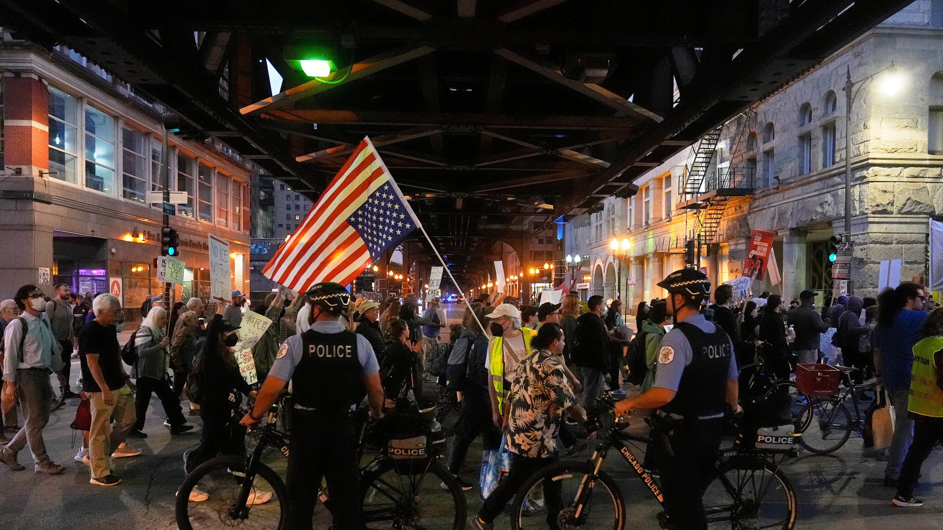 Police officers block a street as demonstrators march at a protest opposing "Operation Midway Blitz" and the presence of ICE, Tuesday, Sept. 9, 2025, in Chicago. (AP Photo/Erin Hooley)