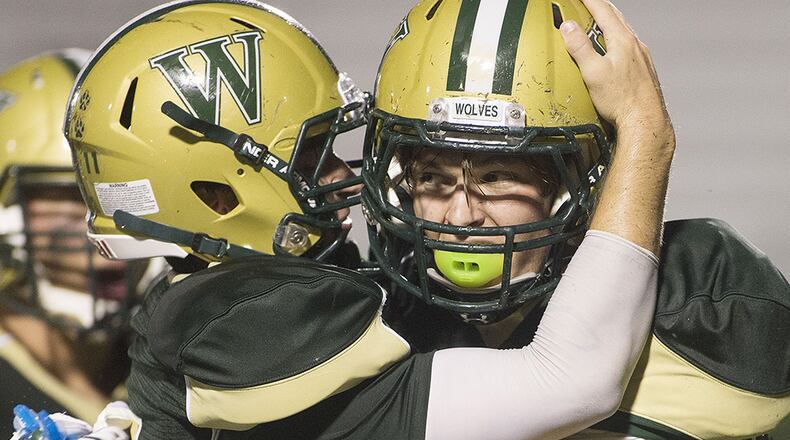 Wesleyan's Drew Aspinwall (left) congratulates Harrison Cook on a pass interception against Pace Academy Knights. (Phil Skinner/Special to AJC)