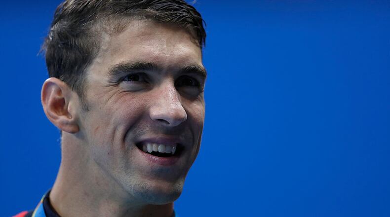 RIO DE JANEIRO, BRAZIL - AUGUST 09: Gold medalist Michael Phelps of the United States kisses his gold medal during the medal ceremony for the Men's 4 x 200m Freestyle Relay Final on Day 4 of the Rio 2016 Olympic Games at the Olympic Aquatics Stadium on August 9, 2016 in Rio de Janeiro, Brazil. (Photo by Clive Rose/Getty Images)