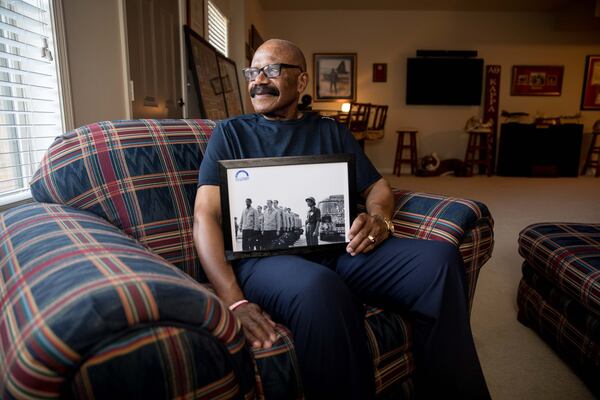 Former POW Lt. Col. James W. Williams poses for a portrait while holding a photo of him and other prisoners of war at Hoa Lo Prison in Vietnam, Friday, Dec. 20, 2019 in Norcross, Ga. Willams was shot down while flying a F-4D Phantom during a mission over North Vietnam. BRANDEN CAMP/SPECIAL