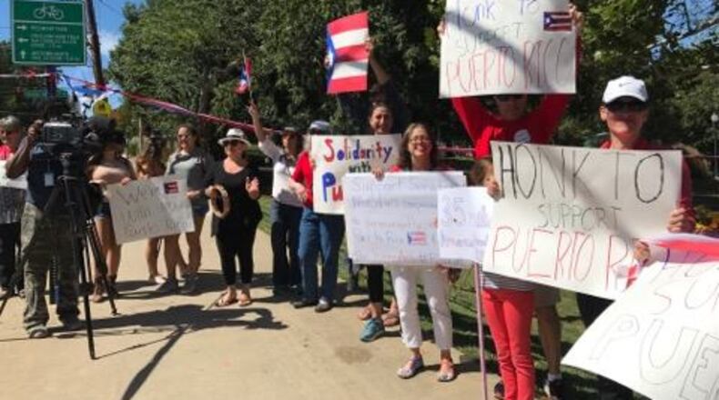 A group of Atlantans shows support for Puerto Rico Sunday at Piedmont Park. (Photo by Laura Murvartian)
