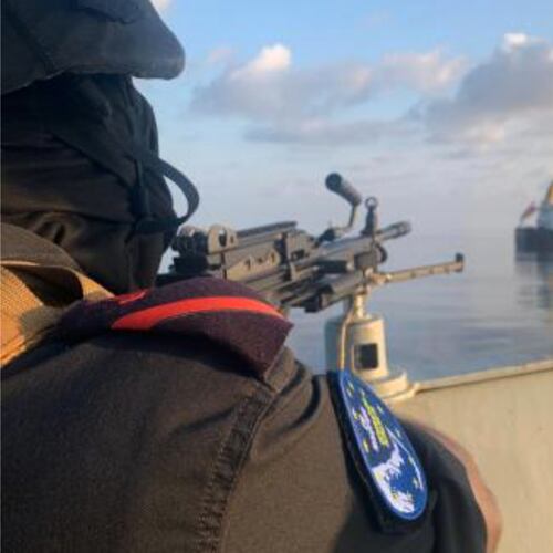 A member of the European Union's Operation Atalanta mans a machine gun aboard the ESPS Victoria while watching the Hellas Aphrodite off the coast of Somalia in the Arabian Sea on Friday, Nov. 7, 2025. (European Union's Operation Atalanta via AP)
