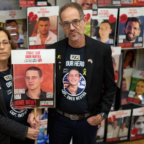 Ronen and Orna Neutra, parents of Omer Neutra, a U.S.-Israeli citizen who was killed in the Hamas-led attacks on Oct. 7, 2023, present a photo of their son in Tel Aviv, Israel, Monday, Oct. 27, 2025. (AP Photo/Ariel Schalit)