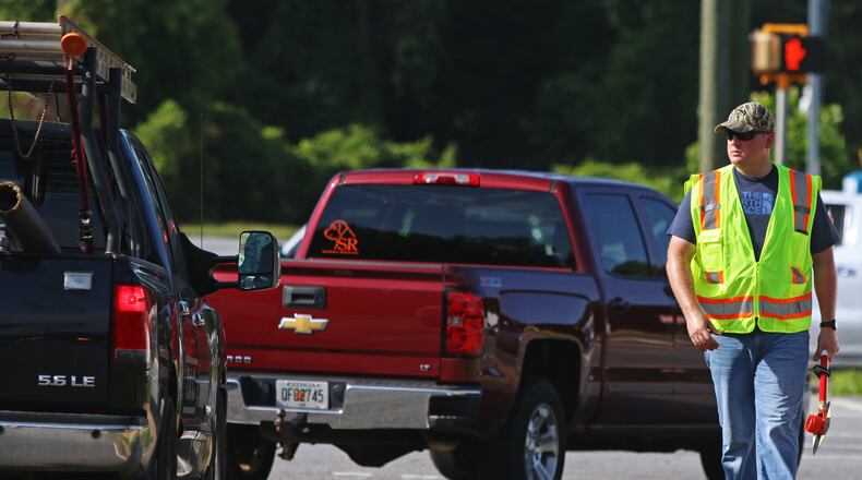 July 16, 2019 Kennesaw- An undercover police officer dressed as a Cobb County Transit worker participates in an undercover traffic operation on Cobb Parkway in Kennesaw, Georgia on Tuesday, July 16, 2019. The Cobb County, Acworth and Kennesaw police departments along with the Georgia State Patrol conducted a Hands-Free Traffic Operation starting at 9 a.m Tuesday morning. The operation was similar to that conducted previously by the Marietta Police Department and involved an undercover element. Officers posed as Cobb County Transit workers to spot drivers not complying with Georgia's hands free driving law. The undercover officers alerted other uniformed officers of violating drivers, who then issued tickets. Christina Matacotta/Christina.Matacotta@ajc.com