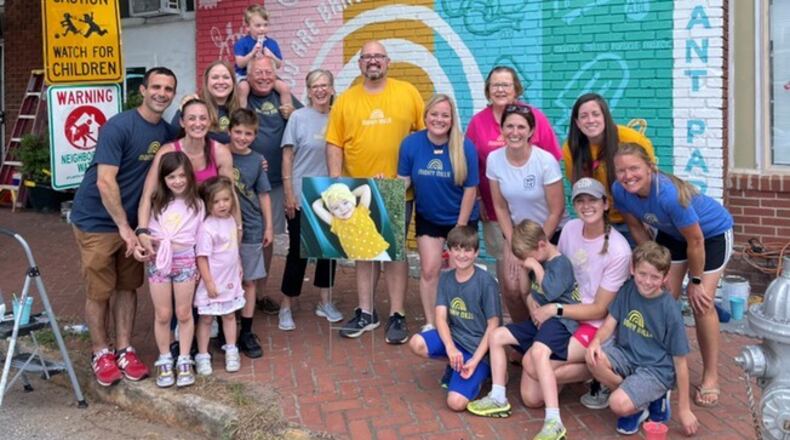 Volunteers painted a mural to support the Mighty Millie Foundation outside of Howdy ATL Cafe in Grant Park.