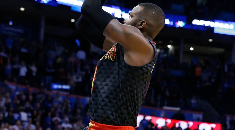 Atlanta Hawks forward Paul Millsap, left, shoots with 12.7 seconds left in front of Oklahoma City Thunder forward Andre Roberson, right, in the fourth quarter of an NBA basketball game in Oklahoma City, Monday, Dec. 19, 2016. Atlanta won 110-108. (AP Photo/Sue Ogrocki)