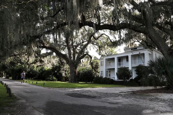 A runner jogs along Bluff Drive at Isle of Hope.