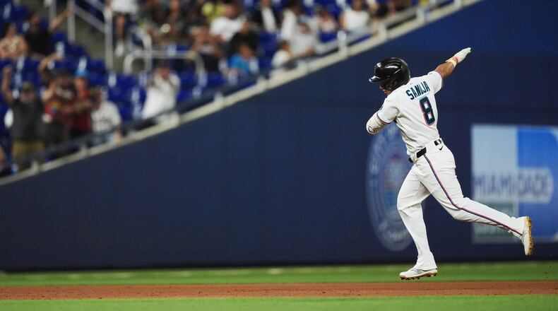 Miami Marlins' Javier Sanoja celebrates as he runs the bases after hitting a grand slam to bring home Jakob Marsee, Connor Norby, and Joe Mack, during the fifth inning of a baseball game against the Atlanta Braves, Monday, May 18, 2026, in Miami. (AP Photo/Rebecca Blackwell)