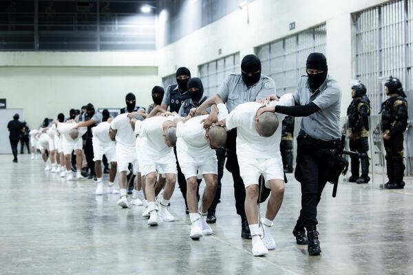 FILE - In this photo provided by El Salvador's presidential press office, prison guards transfer deportees from the U.S., alleged to be Venezuelan gang members, to the Terrorism Confinement Center in Tecoluca, El Salvador, March 16, 2025. (El Salvador presidential press office via AP, File)