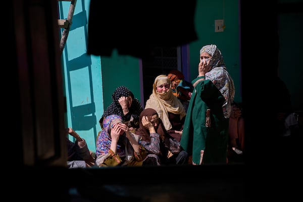 Kashmiri villager women grieve as they sit outside the blown-up family home of Asif Shiekh, a militant who officials say is involved in the deadly attack on tourists in Pahalgam, at Monghama village in Tral, south of Srinagar, Indian controlled Kashmir, Friday, April 25, 2025. (AP Photo/Dar Yasin)