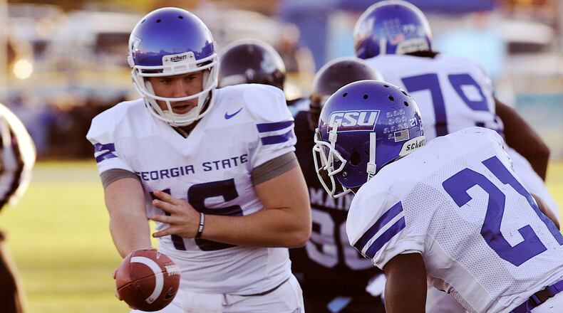 Panthers QB Ben McLane hands off to Travis Evans during first half action.