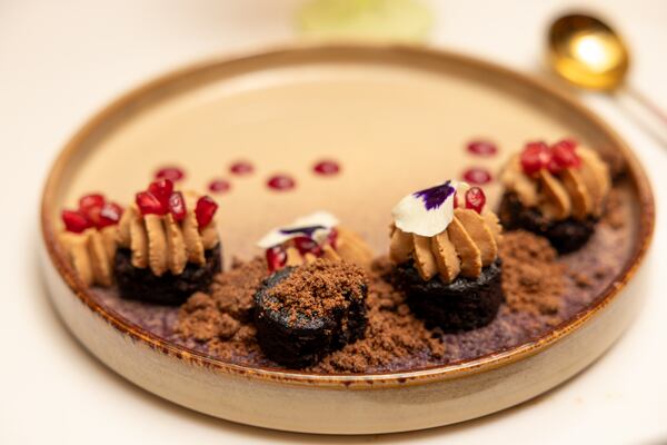 A view of a Araguani chocolate, passion fruit ganache, pomegranate, mole crunch dessert at Bar Ana in Atlanta on Thursday, December 4, 2025. (Arvin Temkar/AJC)