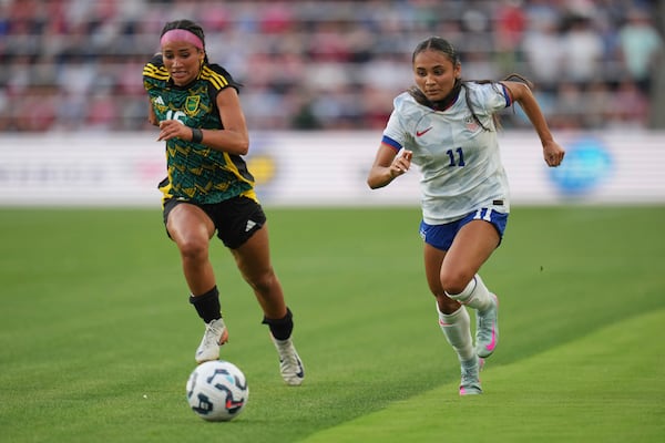 Jamaica's Amelia Van Zantan and United States' Alyssa Thompson (11) chase after a loose ball during the first half of an international friendly soccer match Tuesday, June 3, 2025, in St. Louis. (AP Photo/Jeff Roberson)