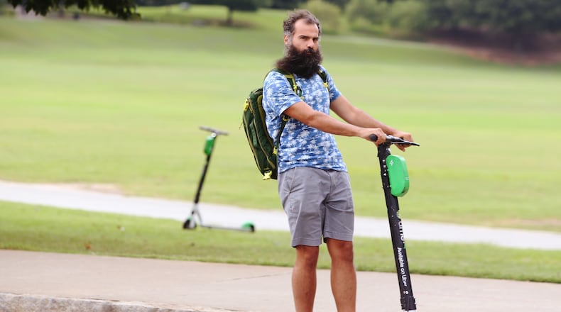 July 18, 2019 Atlanta- A man rides a scooter by Piedmont Park in Atlanta on Wednesday, July 18, 2019. Many Atlantans have embraced e-scooters, while others complain that they violate pedestrians' right of way. Atlanta City Council approved regulations on the scooters at the beginning of 2019, requiring companies to prevent them from being scattered haphazardly on city sidewalks. Christina Matacotta/Christina.Matacotta@ajc.com