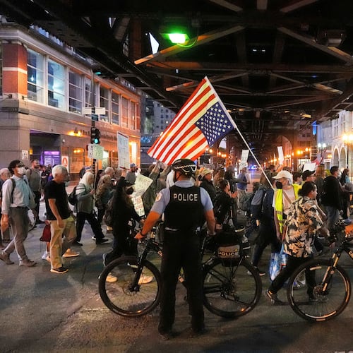 FILE - Police officers block a street as demonstrators march at a protest opposing "Operation Midway Blitz" and the presence of ICE, Sept. 9, 2025, in Chicago. (AP Photo/Erin Hooley, File)