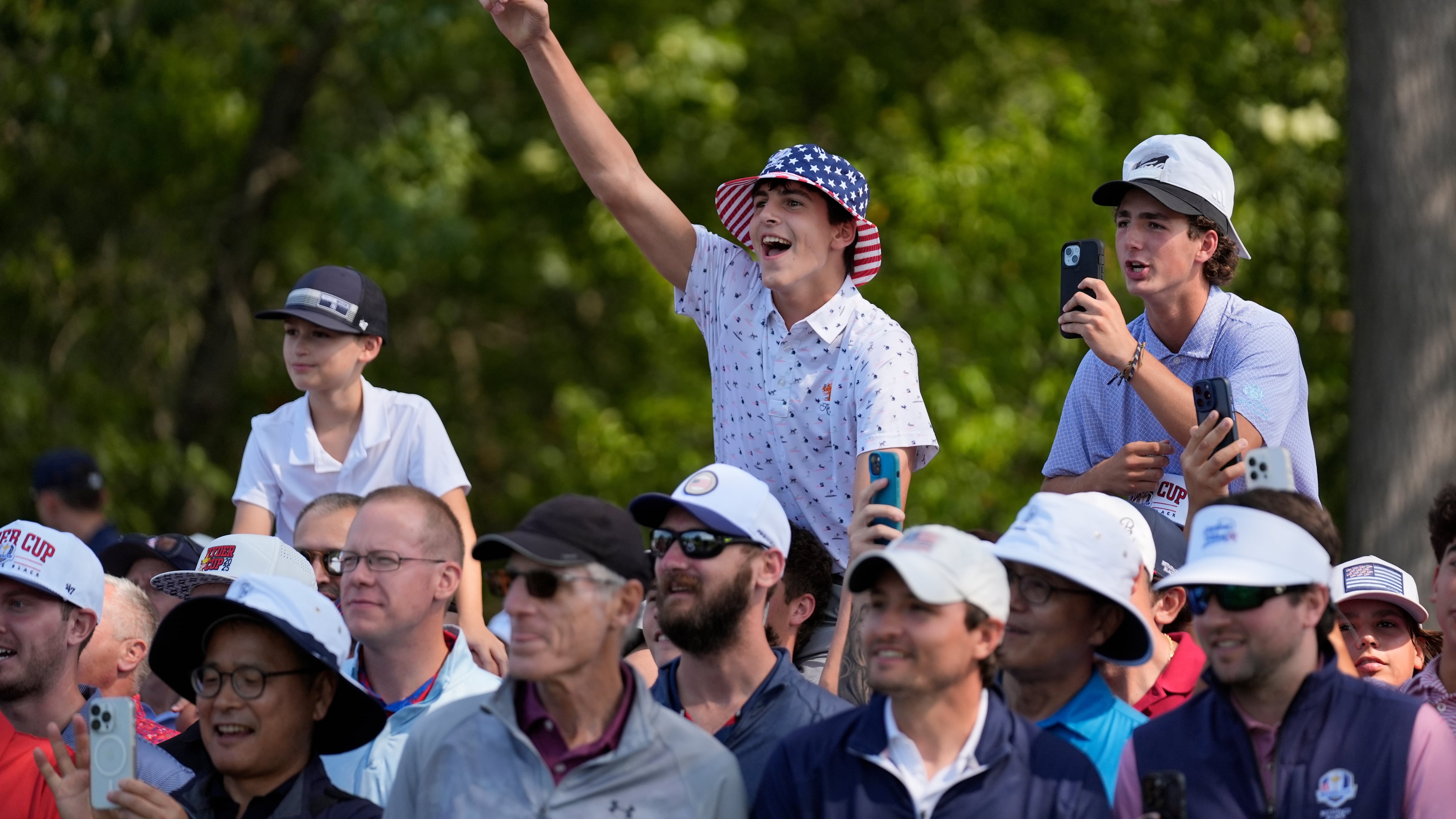 Fans react during a practice round for the Ryder Cup golf tournament, Tuesday, Sept. 23, 2025, in Farmingdale, N.Y., at Bethpage State Park's Black Course. (AP Photo/Robert Bukaty)