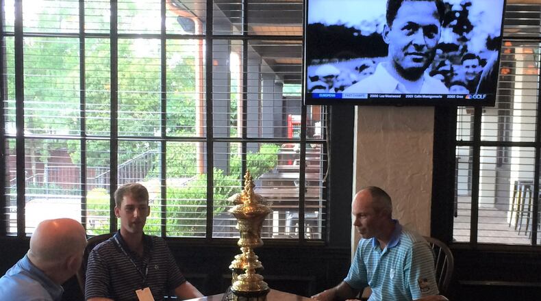With Bobby Jones looking over them, his grandson Bobby Jones IV, Georgia Tech's Andy Ogletree, and former Tech player Matt Kuchar talk golf inside the East Lake clubhouse Tuesday. (Photo by Steve Hummer/AJC)