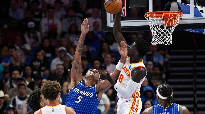 Hawks forward Mouhamed Gueye (center right) blocks a shot by Magic forward Paolo Banchero on Friday, Oct. 24, 2025, in Orlando, Fla. The Hawks scored a 111-107 win over the Magic. (Phelan M. Ebenhack/AP)
