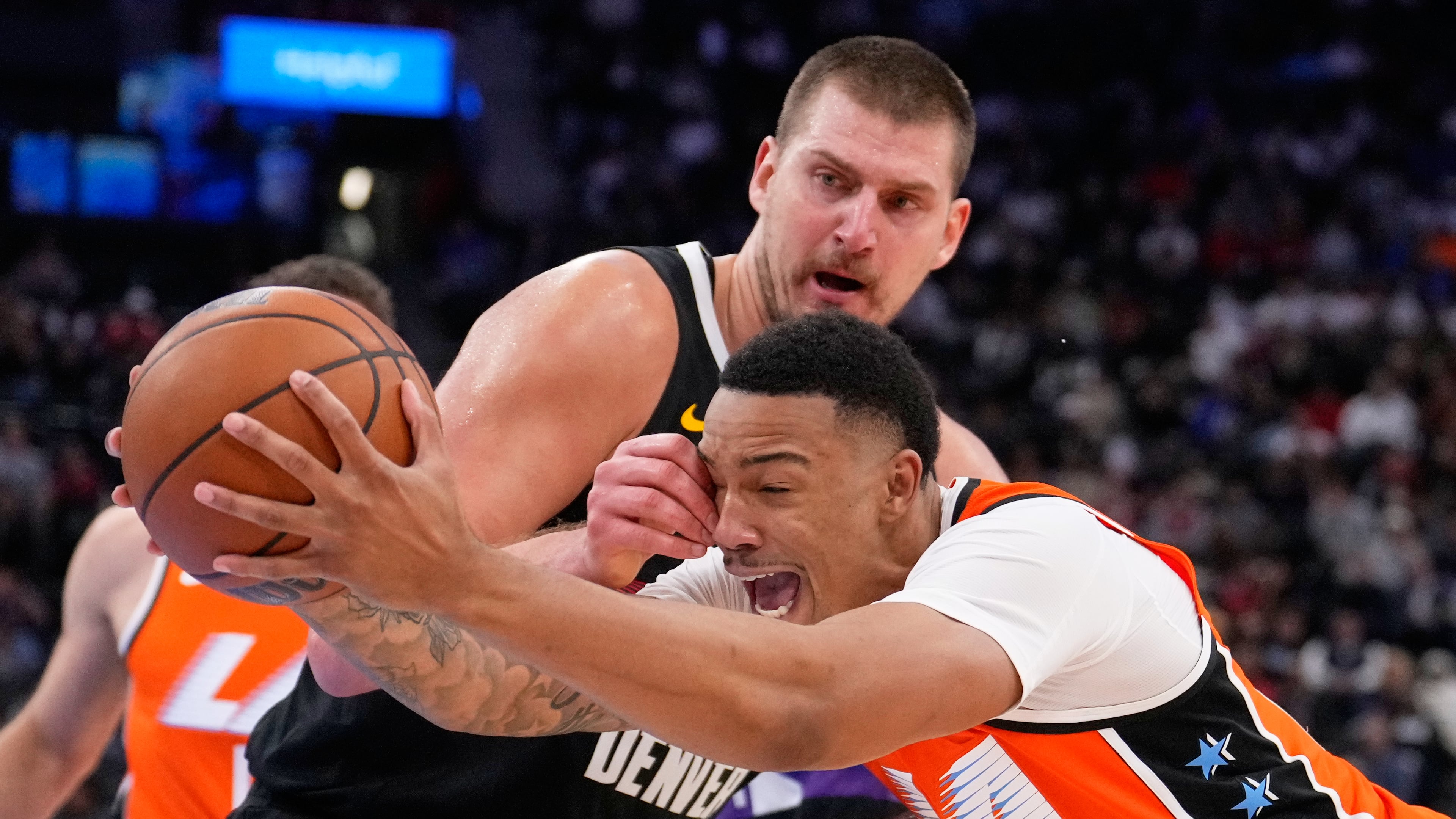 Los Angeles Clippers guard Jordan Miller, right, drives past Denver Nuggets center Nikola Jokic during the second half of an NBA basketball game Wednesday, Nov. 12, 2025, in Inglewood, Calif. (AP Photo/Mark J. Terrill)