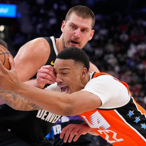 Los Angeles Clippers guard Jordan Miller, right, drives past Denver Nuggets center Nikola Jokic during the second half of an NBA basketball game Wednesday, Nov. 12, 2025, in Inglewood, Calif. (AP Photo/Mark J. Terrill)
