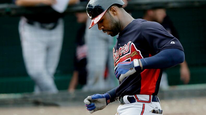 Braves outfielder Jason Heyward tags home plate after belting a line-drive home run to straightaway center field in the sixth inning Sunday against Pittsburgh.