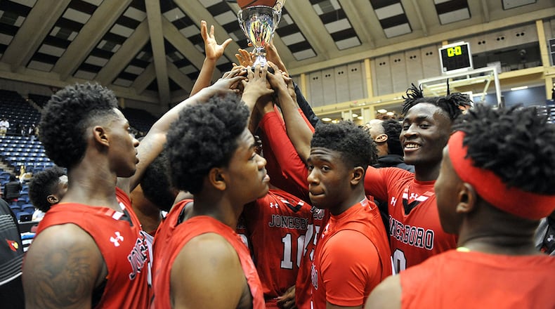 Jonesboro Cardinals players celebrate their second consecutive state Class AAAA title in 2015. (Kent D. Johnson/AJC)
