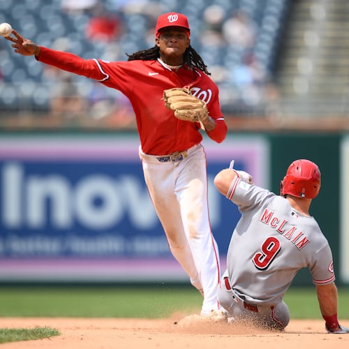 Cincinnati Reds' Matt McLain (9) is out at second base as Washington Nationals shortstop CJ Abrams, top, throws to first base to put out Reds' TJ Friedl for a double play during the eighth inning of a baseball game, Sunday, Aug. 9, 2026, in Washington. (AP Photo/Nick Wass)