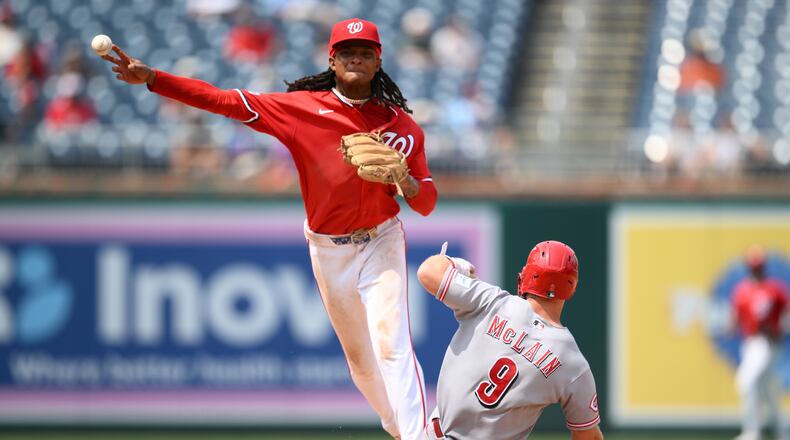 Cincinnati Reds' Matt McLain (9) is out at second base as Washington Nationals shortstop CJ Abrams, top, throws to first base to put out Reds' TJ Friedl for a double play during the eighth inning of a baseball game, Sunday, Aug. 9, 2026, in Washington. (AP Photo/Nick Wass)