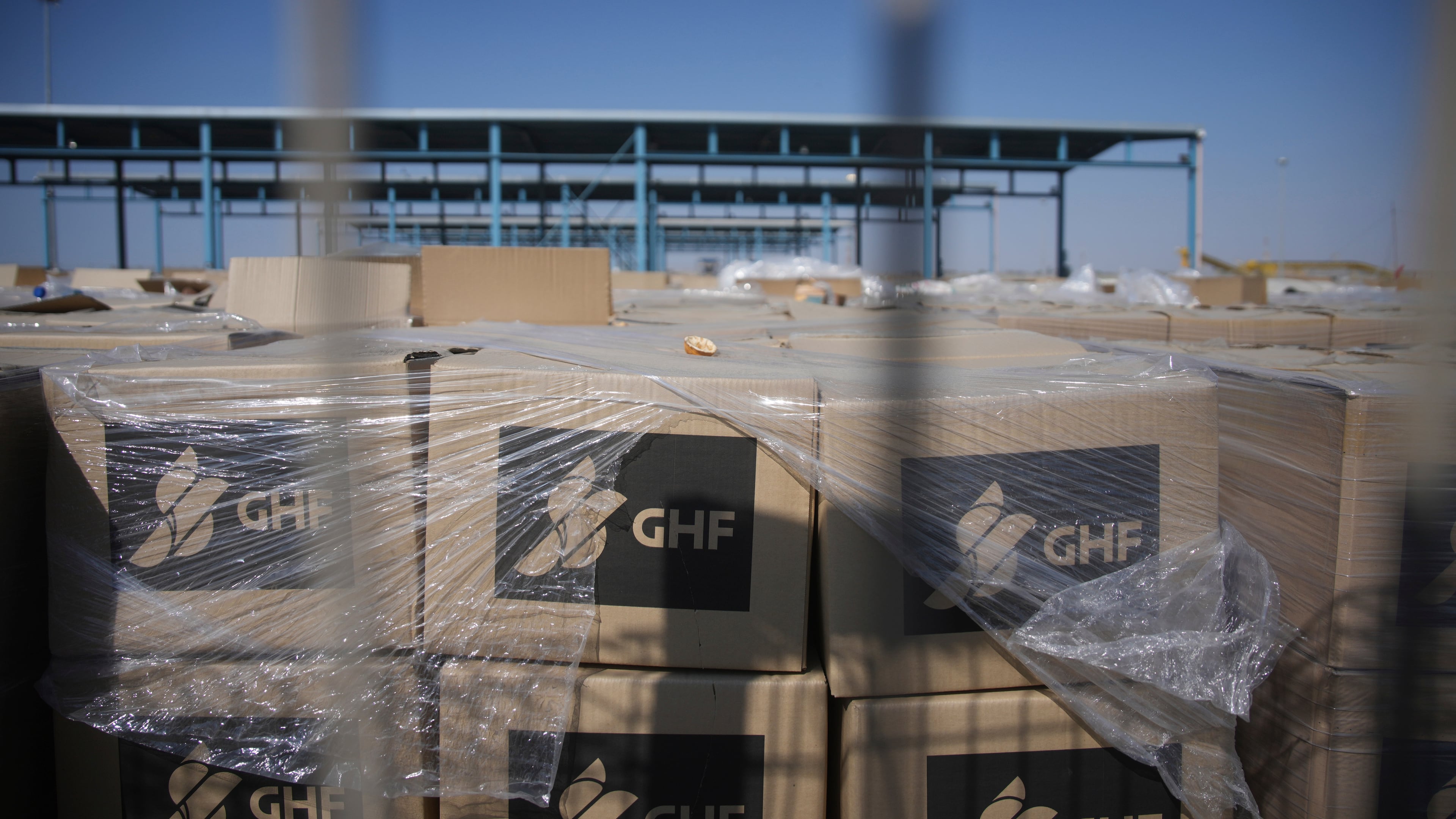 FILE - Piles of humanitarian aid packages from GHFwas, Gaza Humanitarian Foundation, wait to be picked up on the Palestinian side of the Kerem Shalom crossing in the Gaza Strip, Thursday, July 24, 2025. during a media tour organized by the Israeli army. (AP Photo/Ohad Zwigenberg, file)